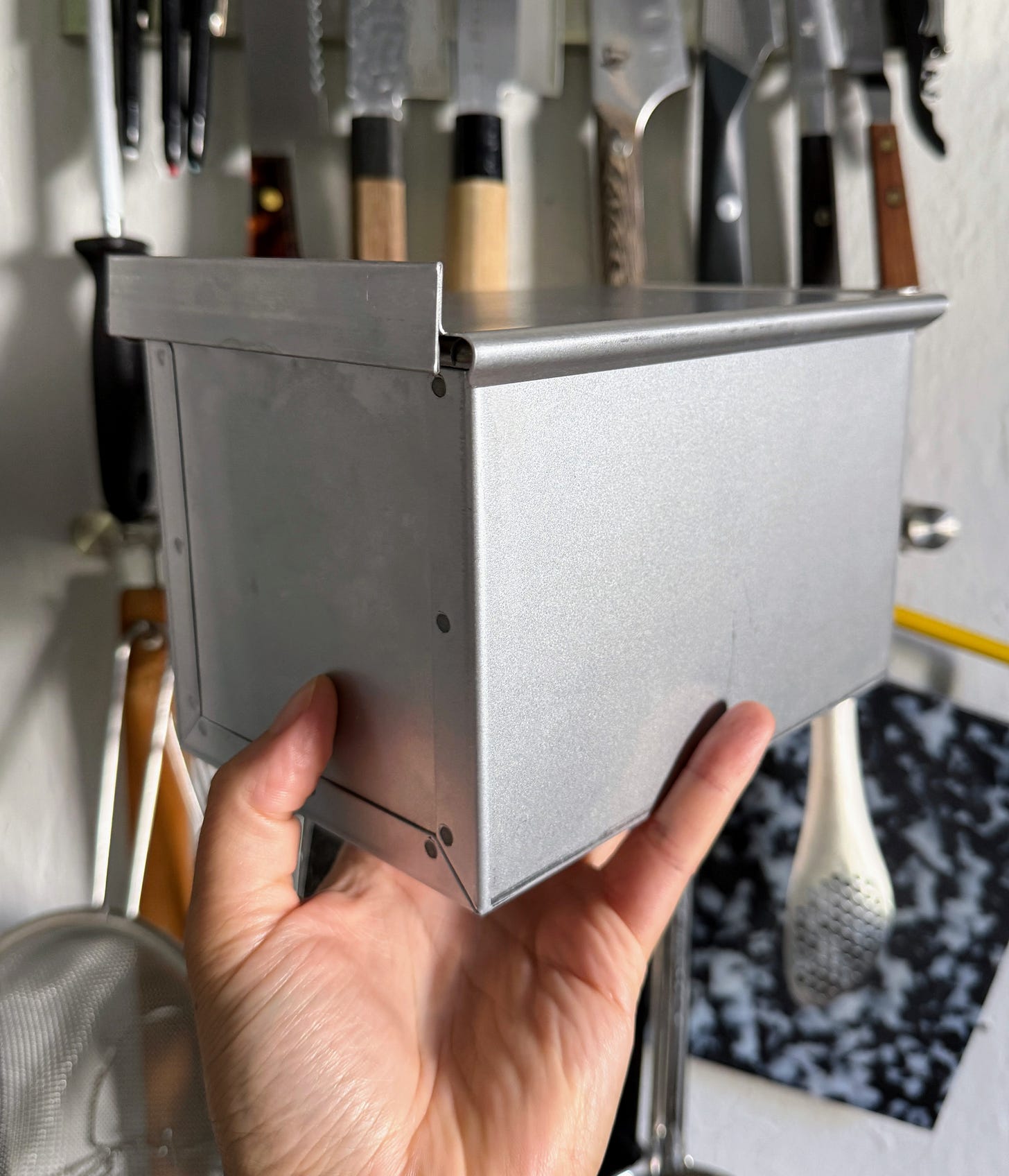 Hand holding Japanese pullman loaf pan