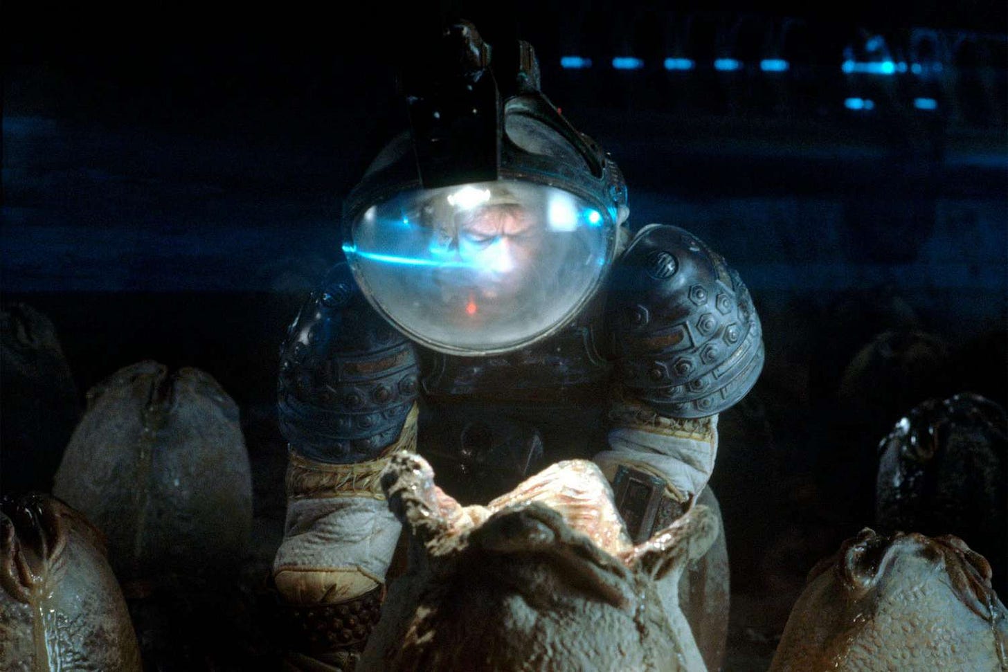 A man in a space suit, leaning over a mysterious and sinister alien egg.