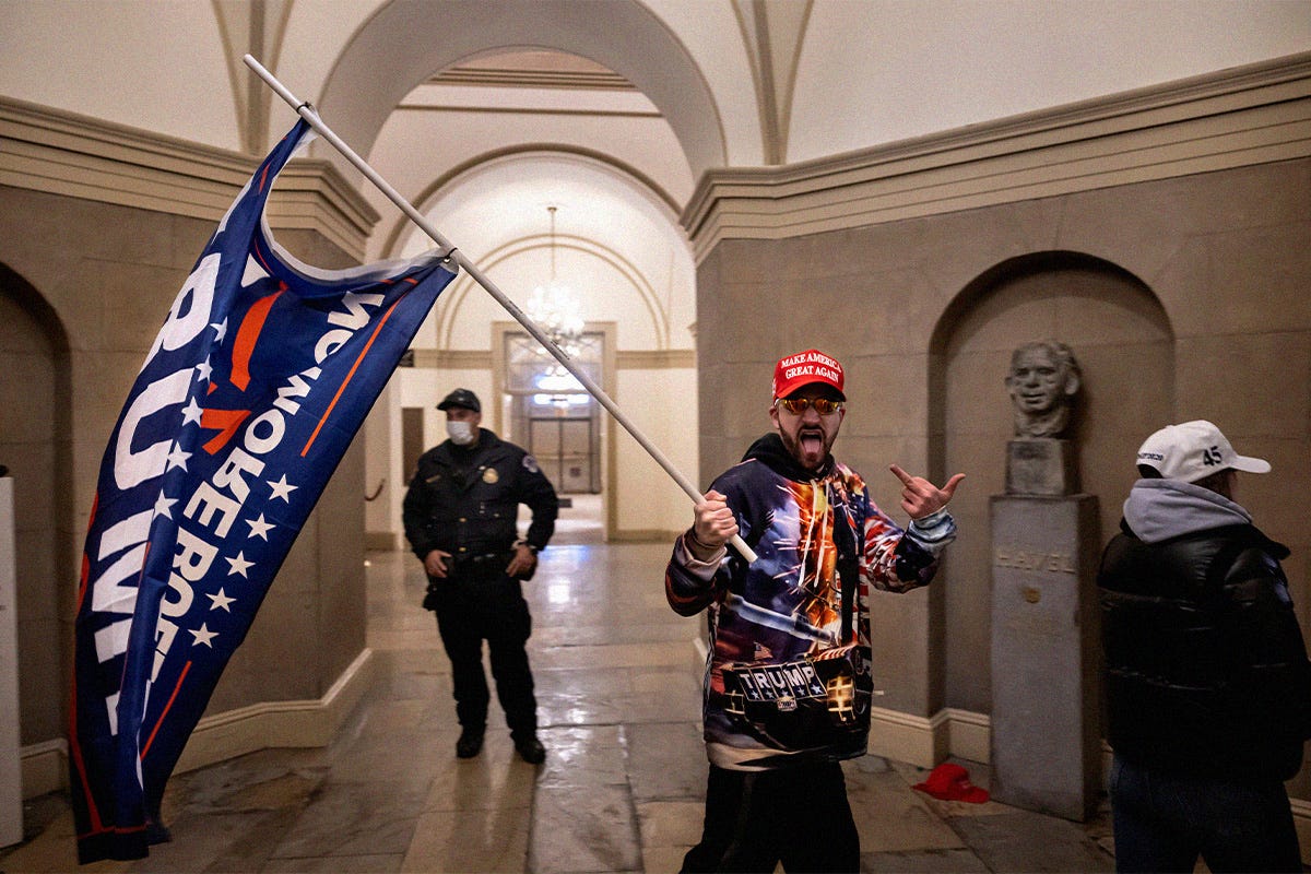 Supporter of US President Donald Trump flips the bird to the photographer as he storms the US Capitol on January 6, 2021, in Washington, DC.