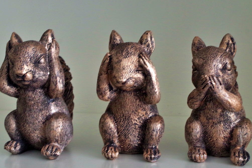 Three bronze squirrel figurines covering their eyes, ears, and mouth.
