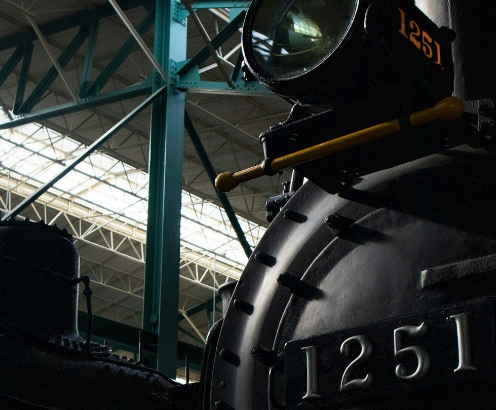 a black train sitting inside of a train station