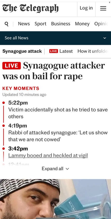 A webpage screenshot from The Telegraph with a headline reading "LIVE Synagogue attacker was on bail for rape." Key moments listed include times and events, such as a victim shot at 5:22pm and a rabbi at 4:19pm. A photo of Jihad al-Shamie, wearing a black and white checkered cap, is visible below the text.