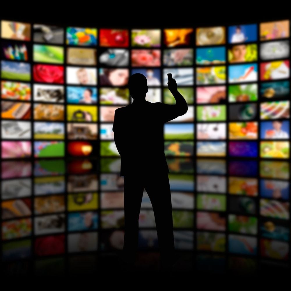 A person examines the big wall of content.