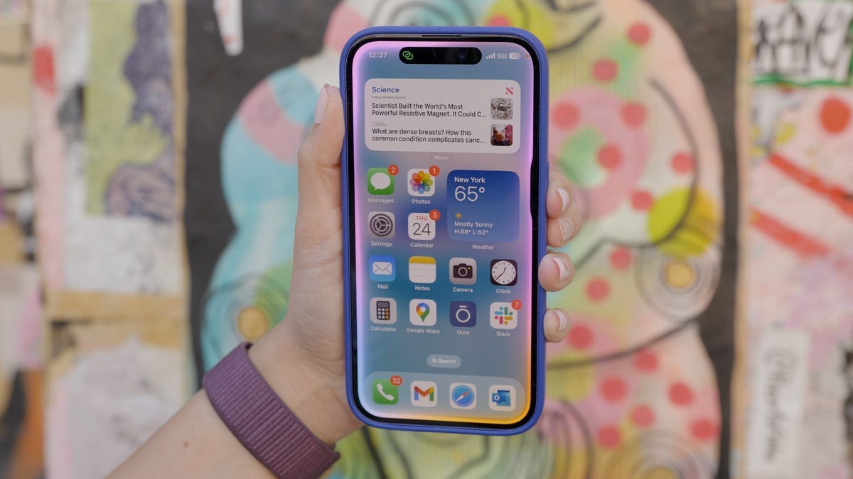 A person&apos;s hand holding up an iPhone