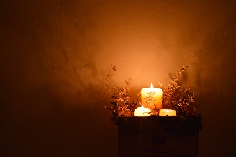 Candles burning with terracotta background
