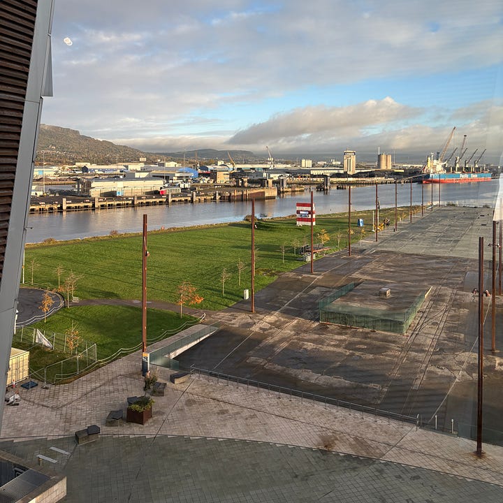 On the left: Launch day ticket No. 116, which admitted 20-year-old Harland & Wolff typist Charlotte Brennan to the stands at Titanic's bow (as displayed at Titanic Belfast). On the right: The Titanic slipway today, seen from Titanic Belfast. The faint white lines in the paving trace the outline of the ship on the spot where she was built.