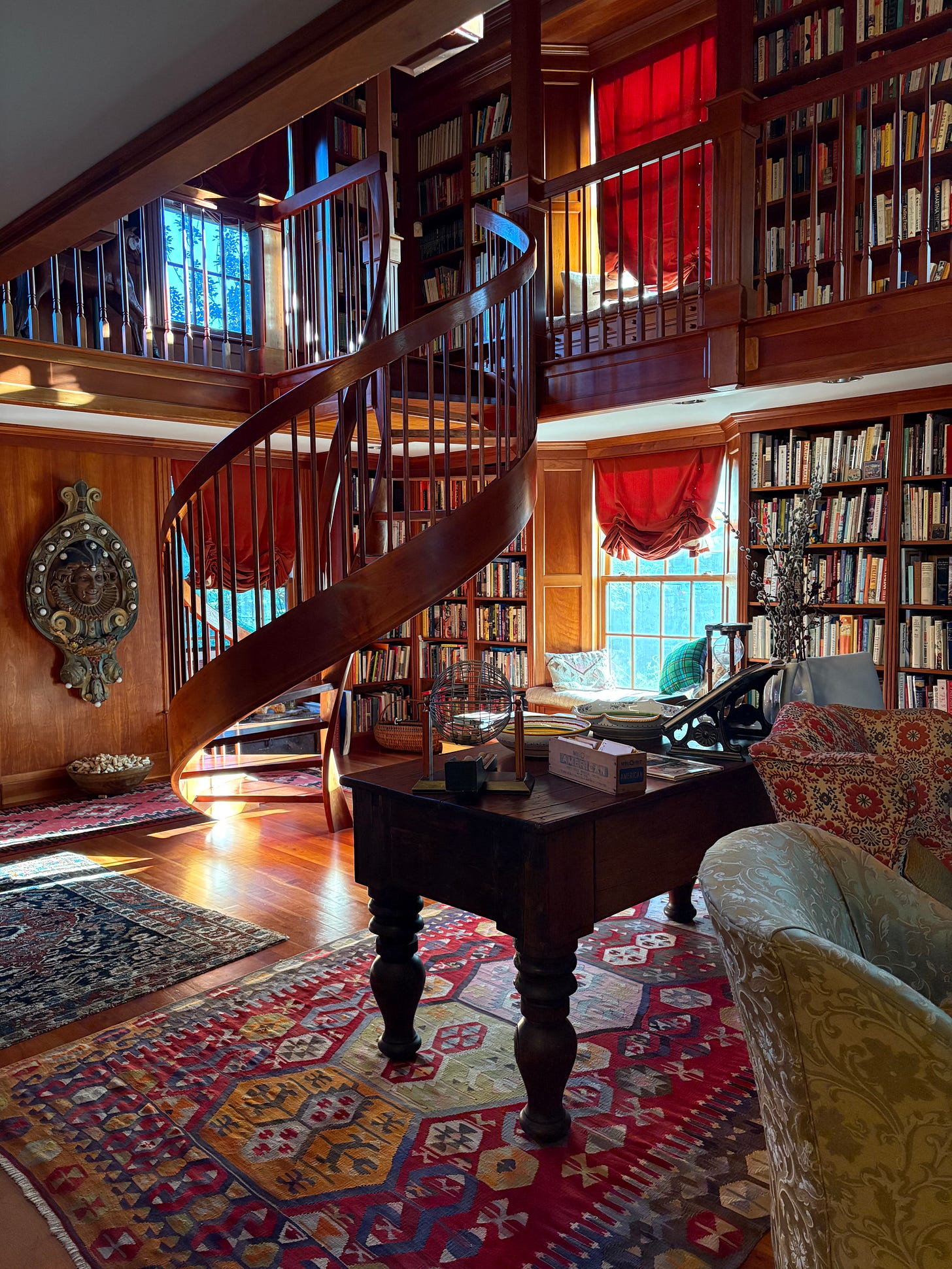 A picture of two stories of books in a wooden library