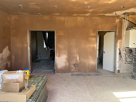 plastered walls; pitched roof; exposed roof beams; underfloor heating; cork flooring; pocket sliding doors
