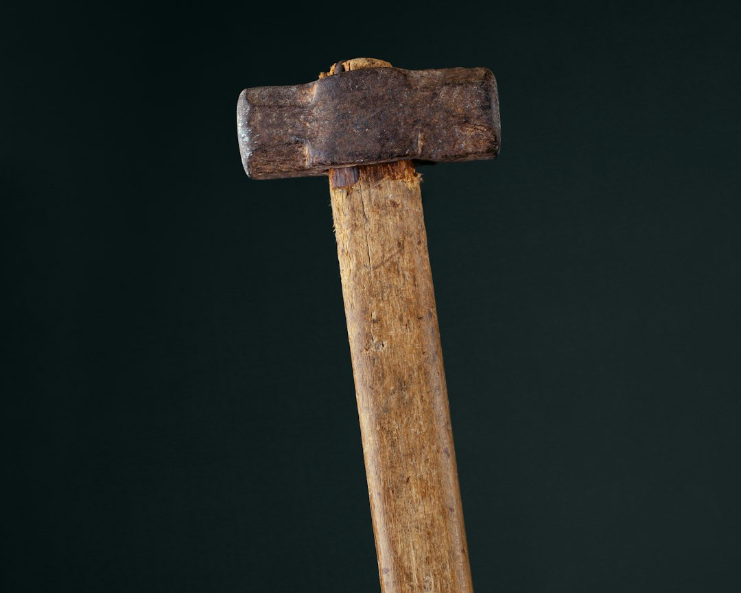 an old wooden hammer with a wooden handle