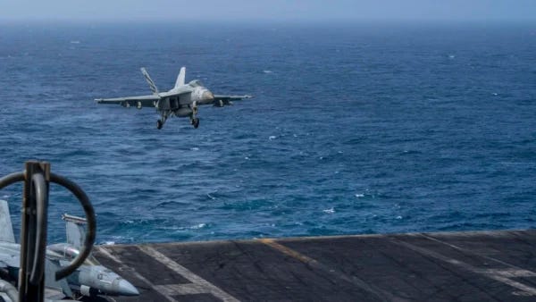 An F/A-18E Super Hornet aircraft assigned to Strike Fighter Squadron 105 prepares to make an arrested landing on the flight deck of the aircraft carrier USS Dwight D. Eisenhower in the Atlantic Ocean.