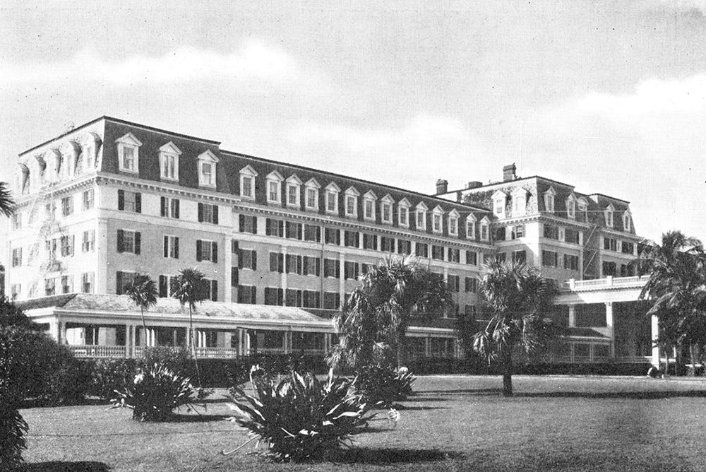 A black and white photo of a large, long six-story building A black and white photo of a large, long six-story building