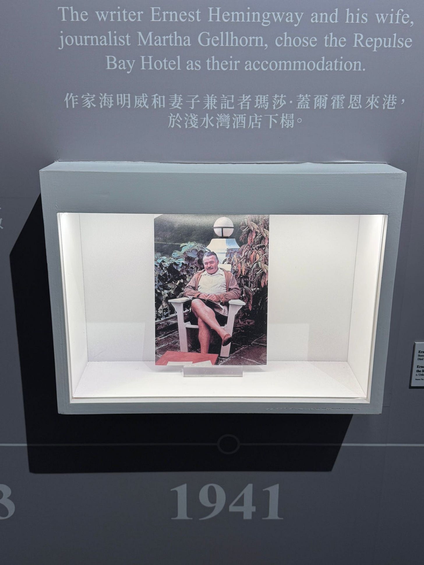 A display case with a picture of a person sitting in a chair

AI-generated content may be incorrect.
