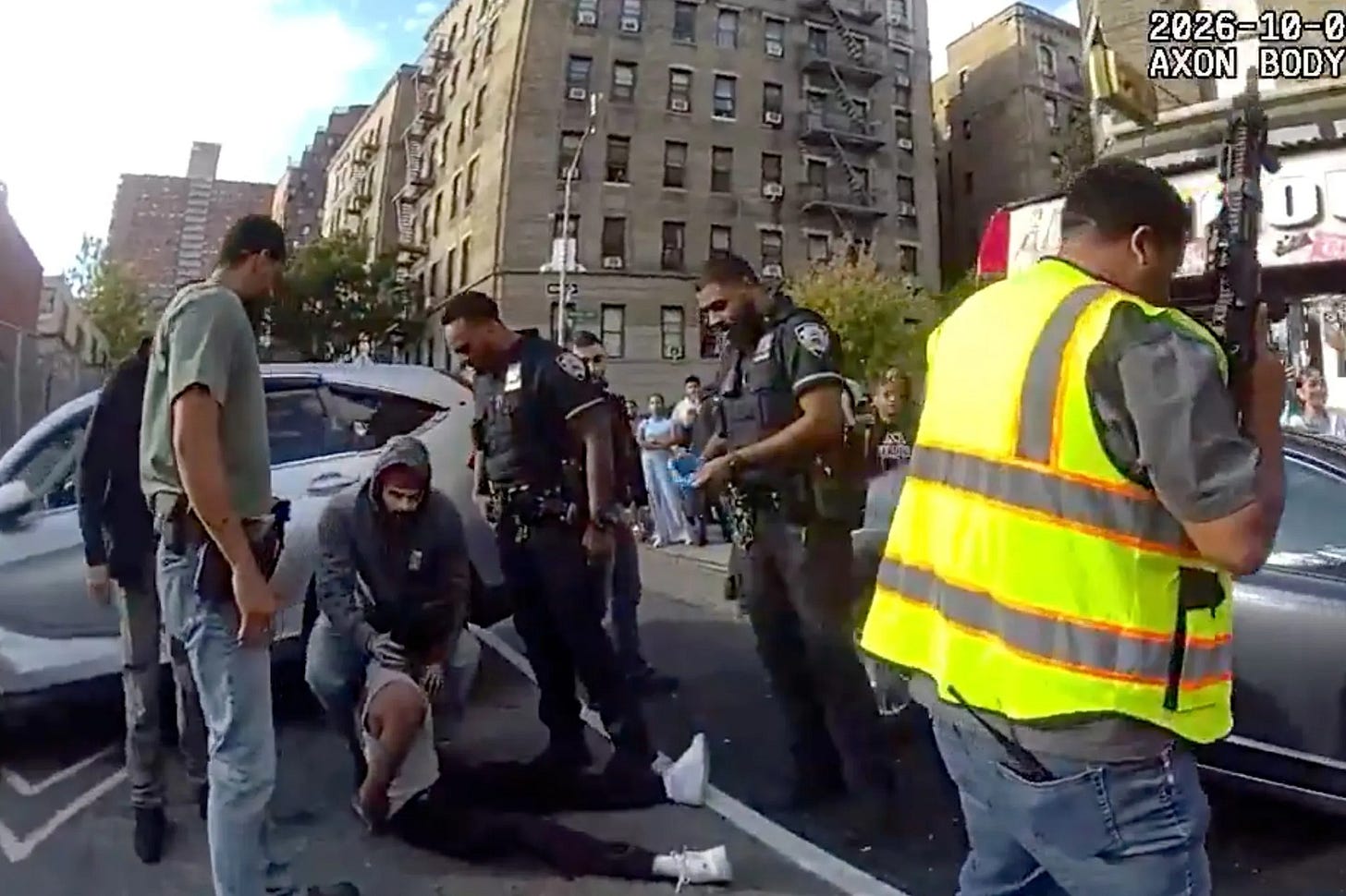 NYPD body camera footage shows federal immigration agents and NYPD officers preparing to take a man injured in an ICE-involved shooting in Marble Hill to the hospital, Oct. 8, 2026. (Screengrab of NYPD Body Camera Footage) NYPD body camera footage shows federal immigration agents and NYPD officers preparing to take a man injured in an ICE-involved shooting in Marble Hill to the hospital, Oct. 8, 2026. (Screengrab of NYPD Body Camera Footage)