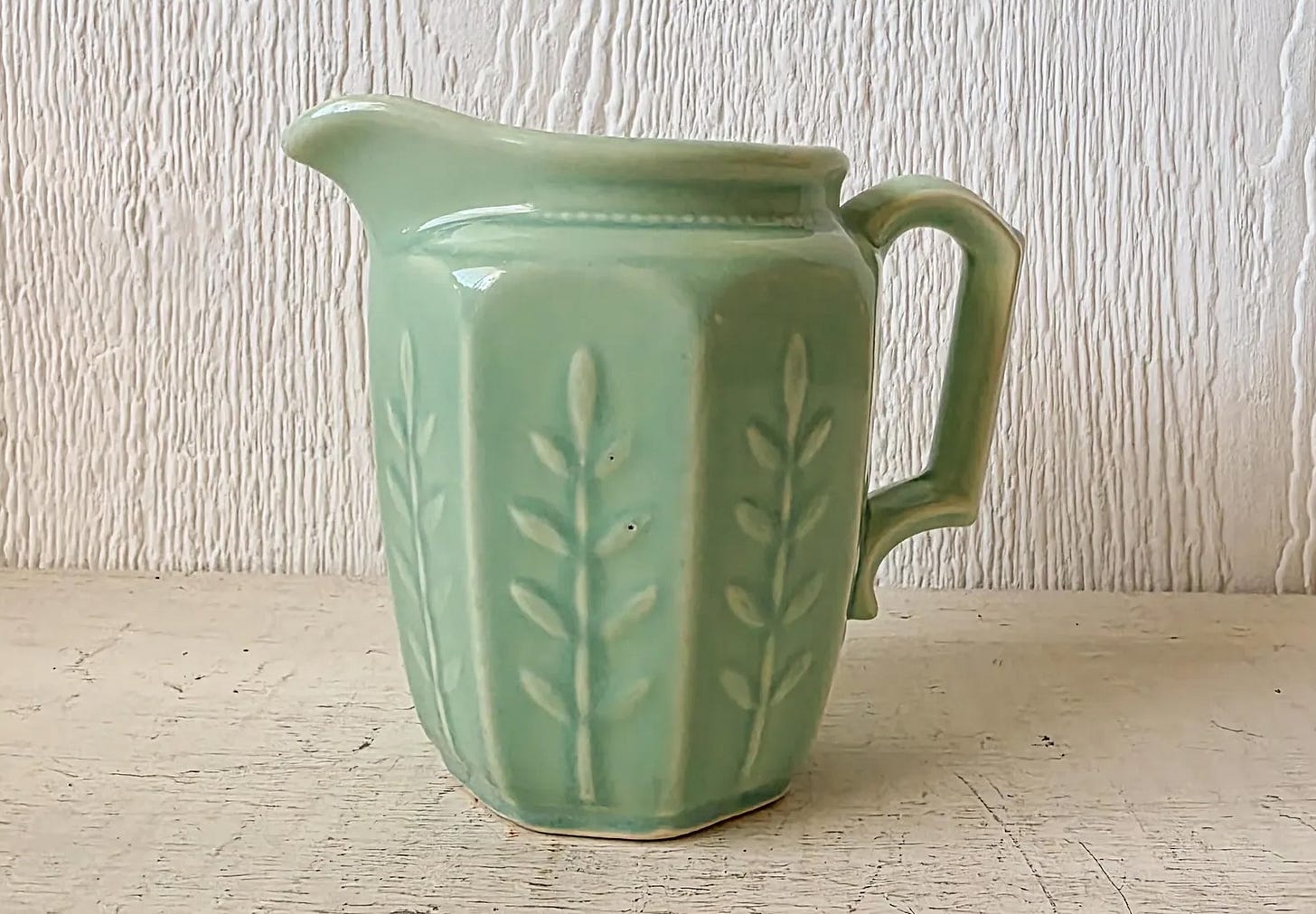 Green jadeite pitcher with wheat pattern.