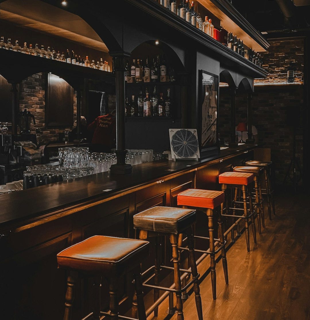 a bar with stools and shelves