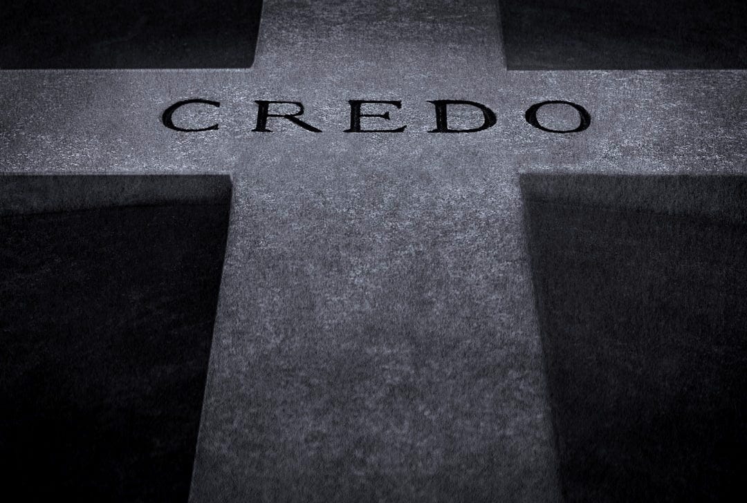 a black and white photo of a cross with the word credo on it a black and white photo of a cross with the word credo on it
