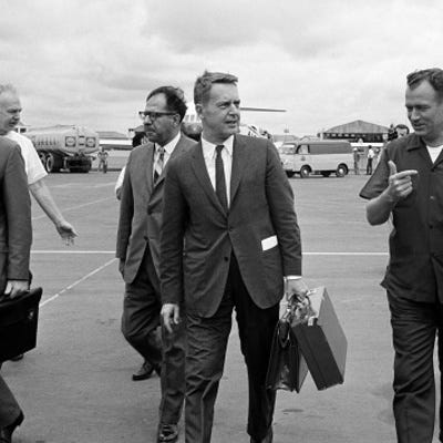 A group of men walking on a tarmac

AI-generated content may be incorrect.