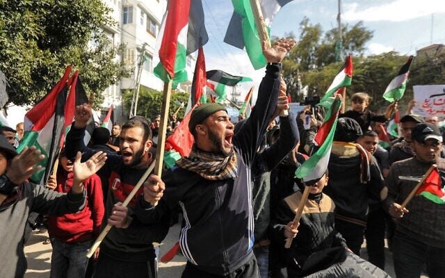 Palestinian demonstrators chant slogans and wave Palestinian flags during a protest against US President Donald Trump's expected peace plan proposal in Gaza City on January 28, 2020. (Mahmud Hams/AFP) Palestinian demonstrators chant slogans and wave Palestinian flags during a protest against US President Donald Trump's expected peace plan proposal in Gaza City on January 28, 2020. (Mahmud Hams/AFP)