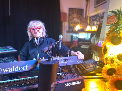 Musical equipment and people inside a recording studio