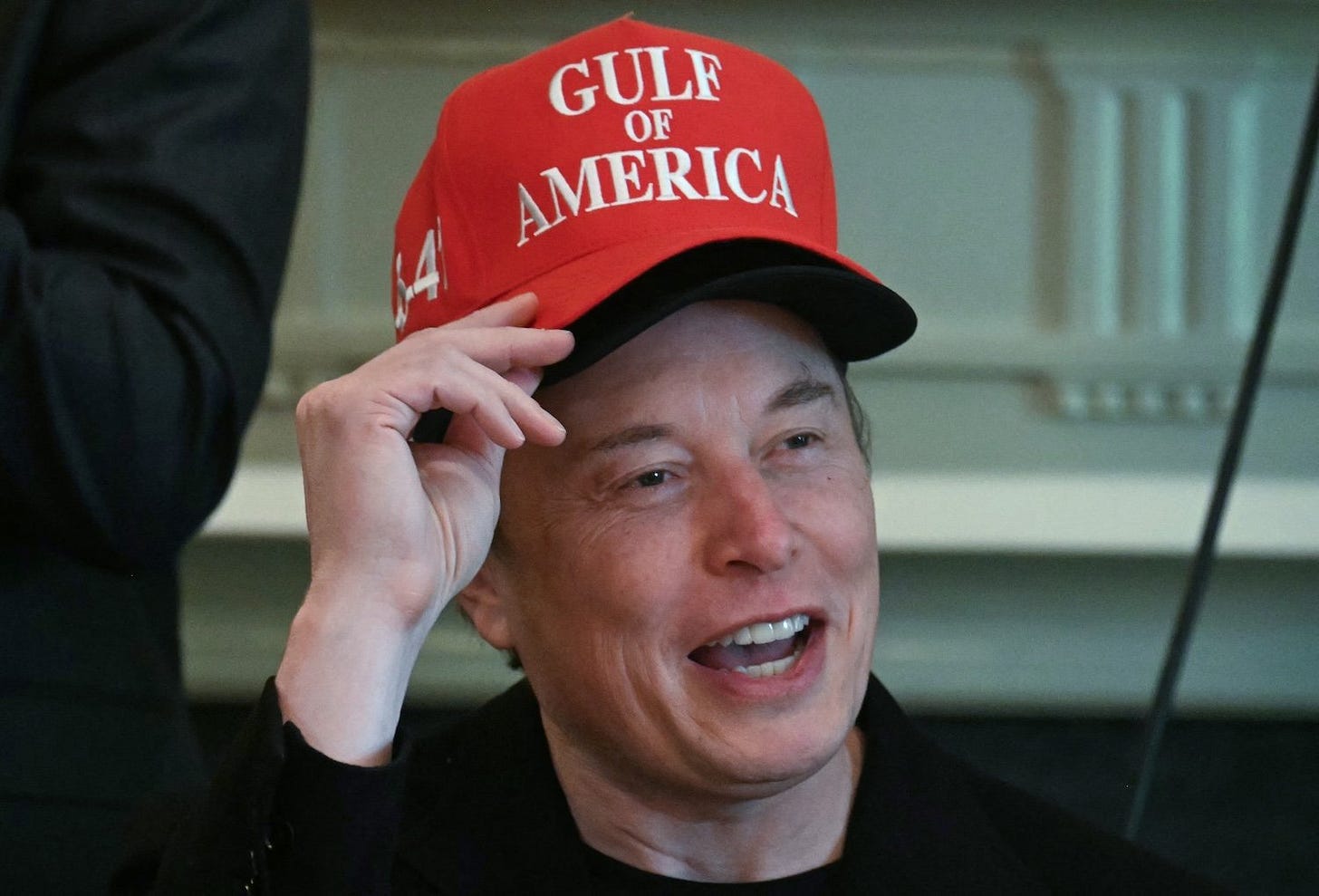 Elon Wears Two Hats During Trump Meeting in Desperate Bid for Attention