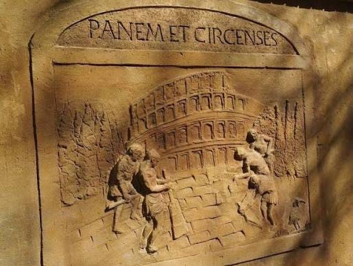 I read the part where Plutarch said Panem et Circenses and relating to  Katniss that it's a Latin phrase translating to Bread and Circuses. He then  proceeds to explain that “in return