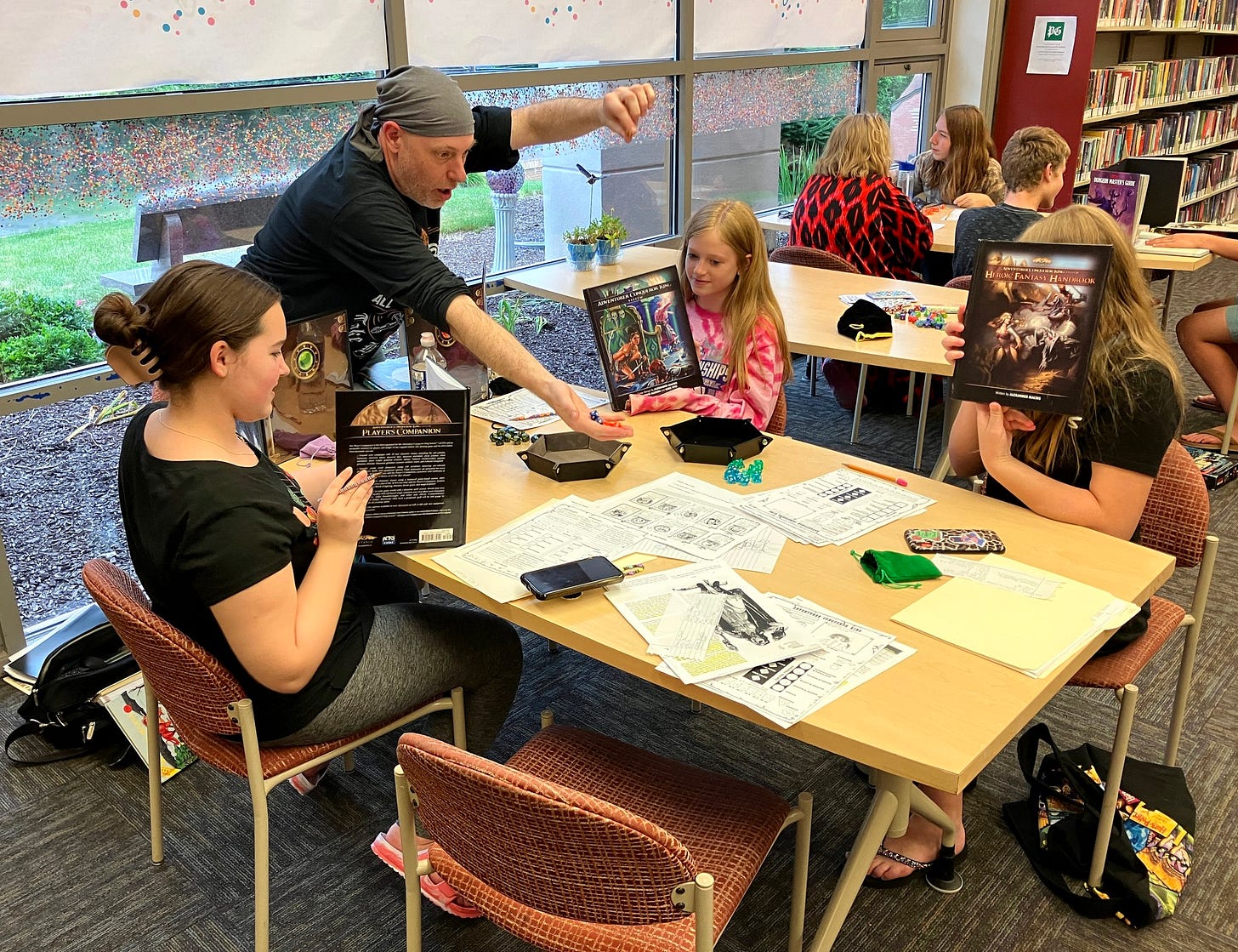 May be an image of 8 people, people studying, book and text
