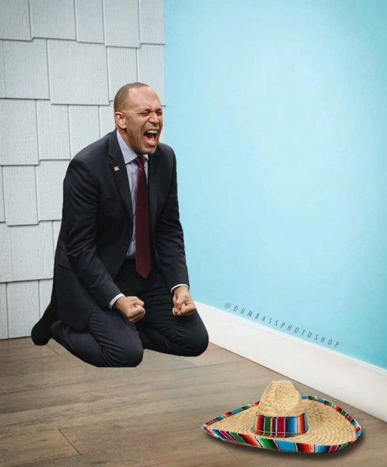 A man in a dark suit and red tie, kneeling on a wooden floor with clenched fists and an open mouth, appearing to shout. A colorful sombrero with a striped band lies on the floor nearby. A light blue wall and white tiled wall are in the background. A watermark reading "Dumbass Photoshop" is visible.
