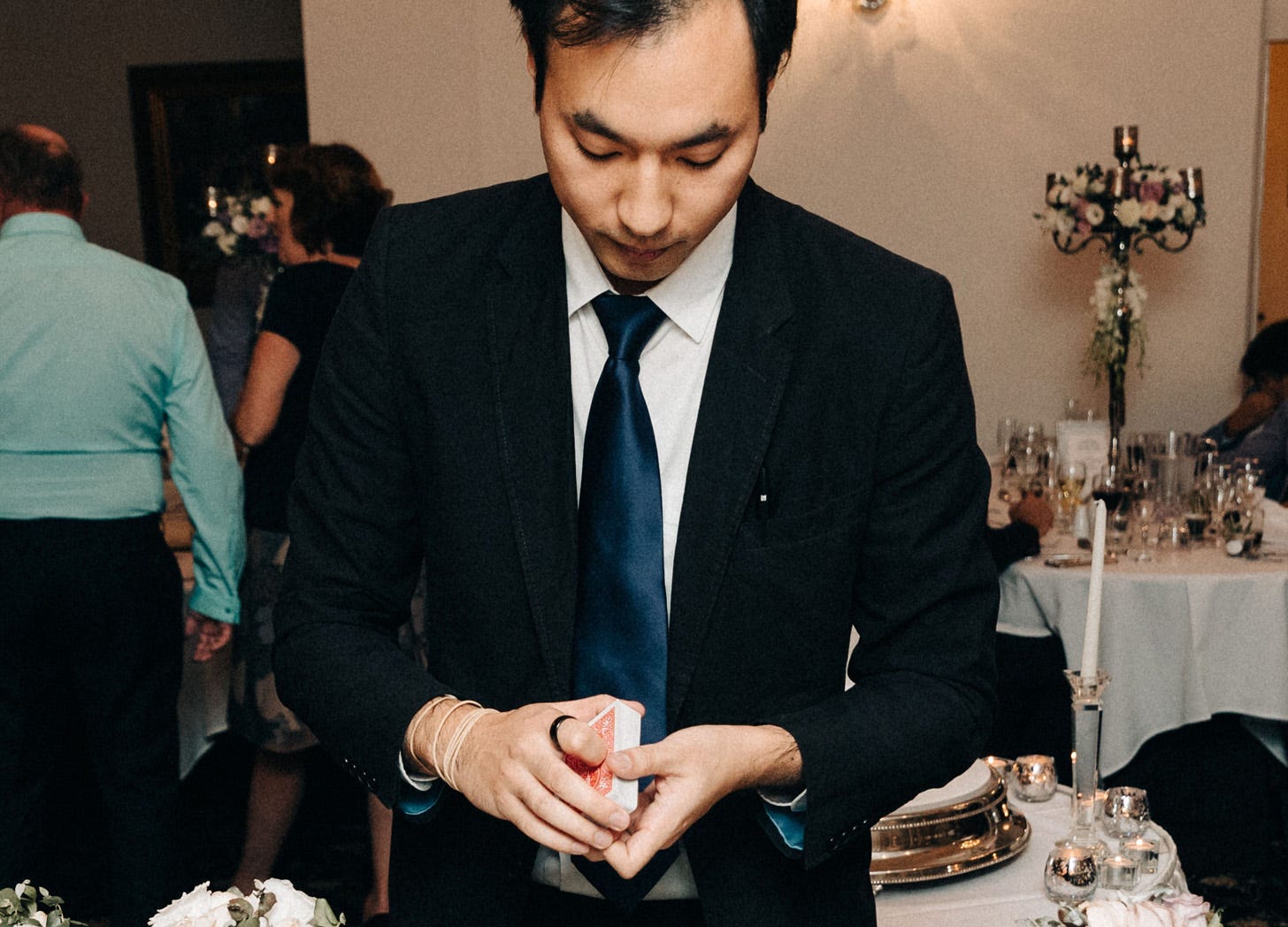 Magician David Ung holding a deck of cards