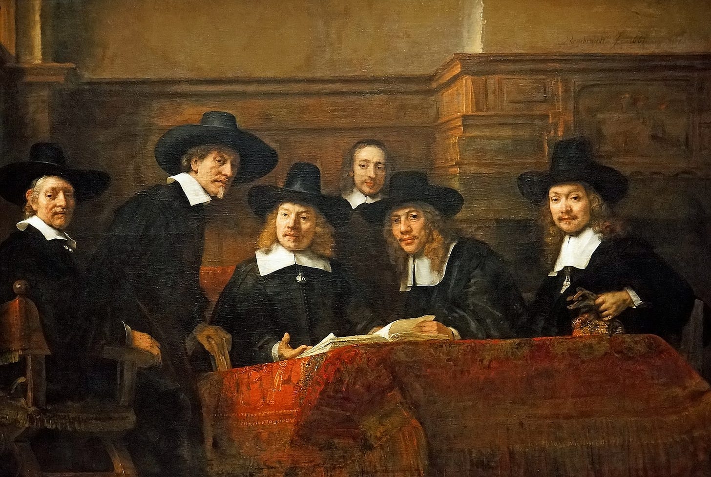 Oil painting showing six men wearing black attire and wide-brimmed hats sit around a table covered with an ornate red cloth, engaged in conversation. *The Syndics of the Drapers' Guild* (1662) by Rembrandt via [Wikimedia](https://en.wikipedia.org/wiki/Rembrandt#/media/File:Netherlands-4183_-_The_Syndics,_Rembrandt.jpg)