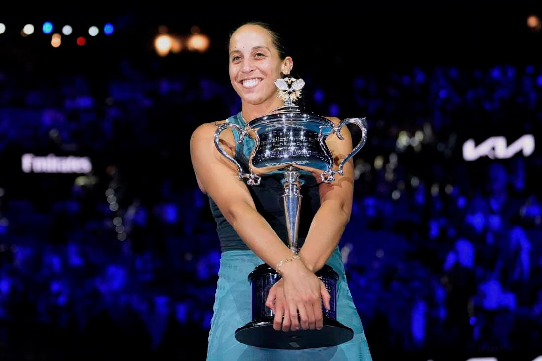 Madison Keys of the U.S. hugs the Daphne Akhurst Memorial Cup after defeating Aryna Sabalenka of Belarus in the women's singles final at the Australian Open tennis championship in Melbourne, Australia, Saturday, Jan. 25, 2025. (AP Photo/Asanka Brendon Ratnayake)