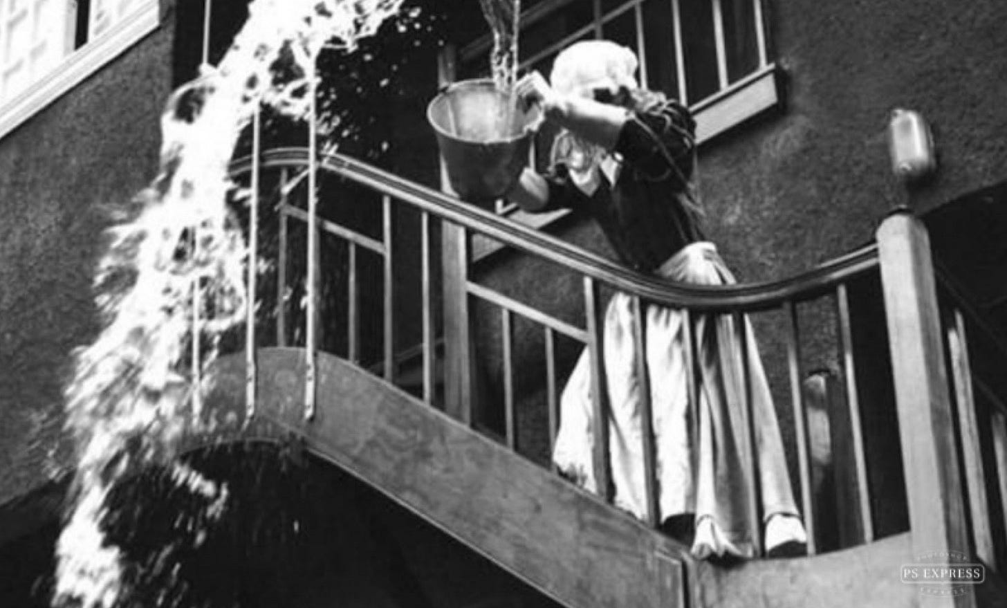 A person pouring water into a bucket

Description automatically generated