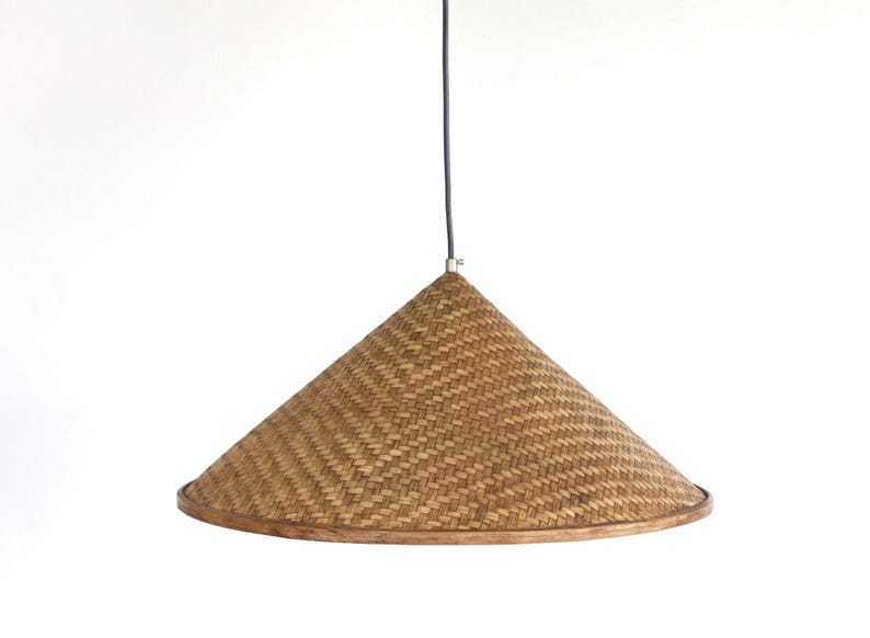 May include: A woven conical pendant light fixture with a natural brown finish. May include: A woven conical pendant light fixture with a natural brown finish.