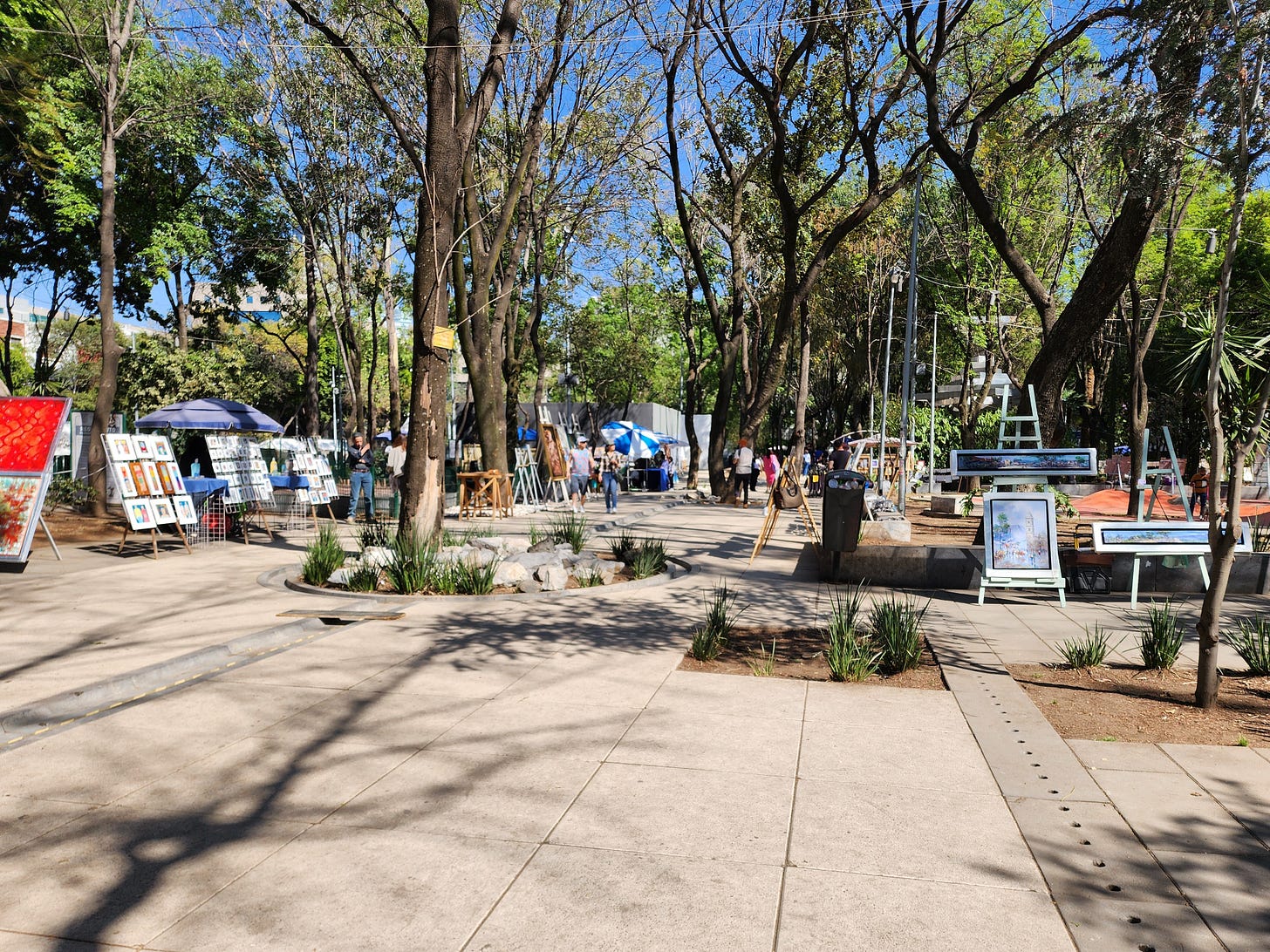 Local artists displaying paintings for sale at the outdoor Jardin del Arte Sullivan market on Sunday
