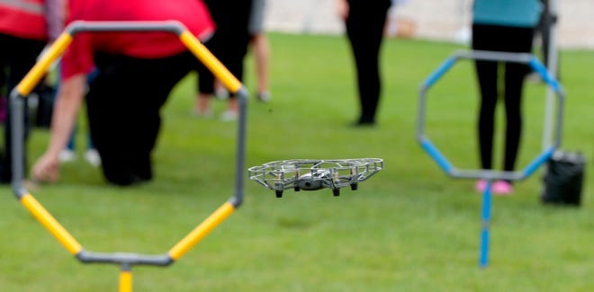 A drone being controlled by Honesty Brooks, 12 of Detroit goes through an obstacle course during youth drone demo day put on by Code 313 in front of Ford’s Michigan Central Station in Detroit on Saturday, September 9, 2023.