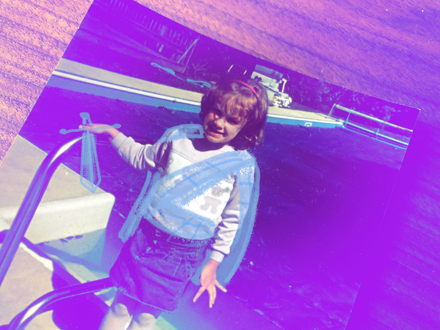 Photo of author as a child, a tartan, sword and battle makeup doodled on her face.