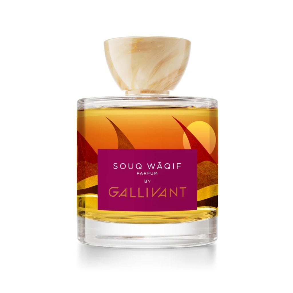 A bottle of 'Souq Waqif' parfum by Gallivant, featuring a decorative label with warm colors and a wooden cap.