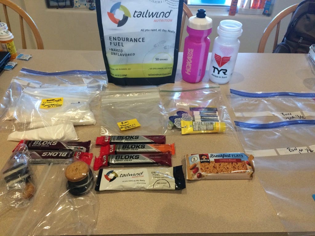 Photo of a wide selection of triathlon nutrition and electrolytes that have been sorted for a race into transition packets. 