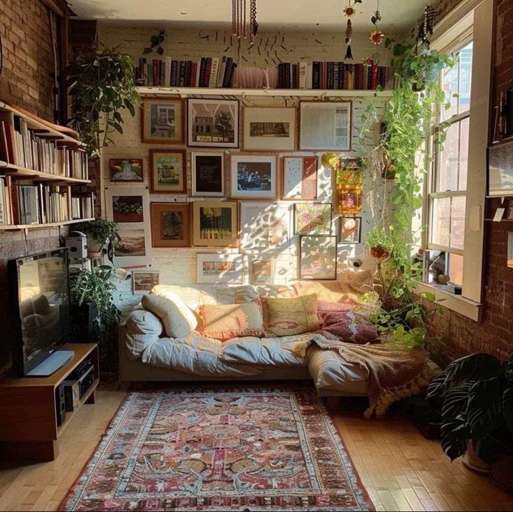This may contain: a living room filled with furniture and lots of books on the wall above it's windows