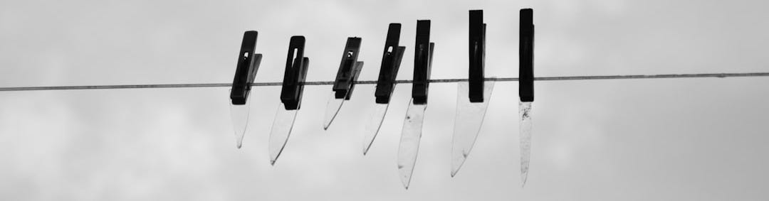 a black and white photo of a line of knives a black and white photo of a line of knives