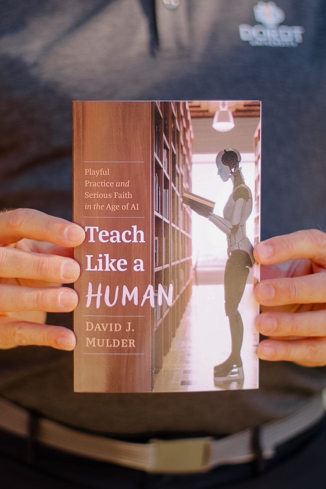 A photo of Dr. Dave holding a copy of Teach Like a Human