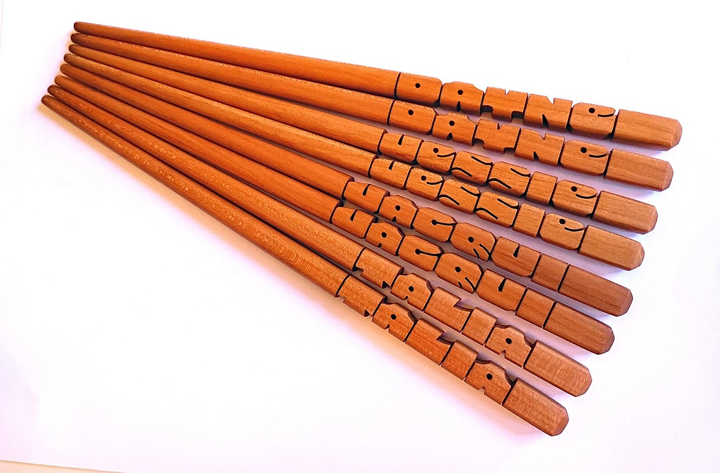 Four pairs of Cherry wood name chopsticks. Four pairs of Cherry wood name chopsticks.
