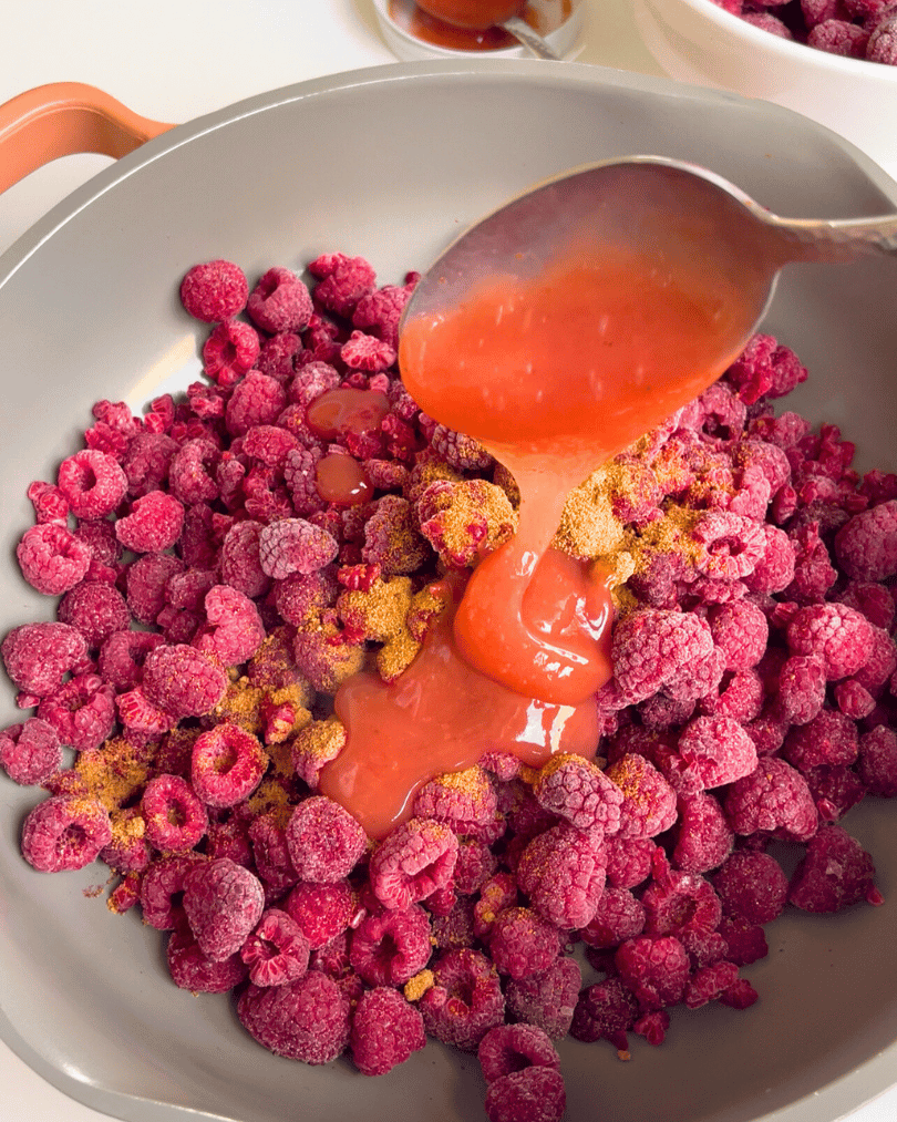 frozen raspberries in a grey pot with coconut sugar and pink sea moss gel