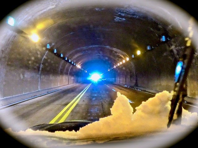 A car driving through a tunnel

Description automatically generated