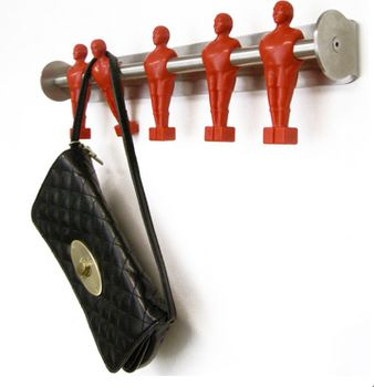 This may contain: a purse hanging on a wall with red figures attached to it This may contain: a purse hanging on a wall with red figures attached to it