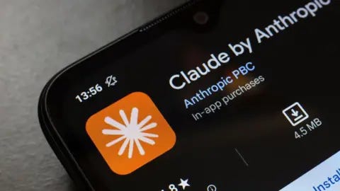 Getty Images The Claude app as displayed on a phone screen. It is an orange logo with a white splash in the middle. 