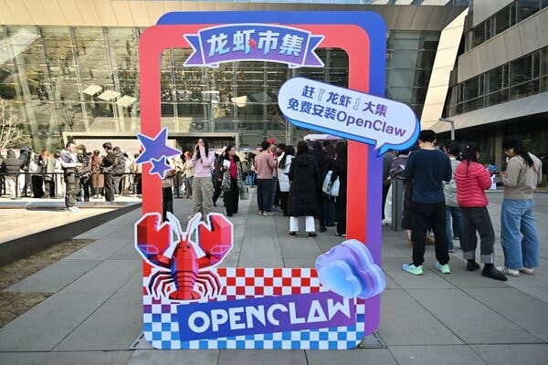 A large red and blue signboard features a lobster graphic and Chinese characters. Many people gather behind it, some looking at their phones.