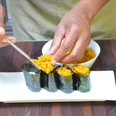 Three gunkan maki sushi pieces, each featuring a different plant-based topping: natto, spicy carrot tuna, and amaranth caviar. Each piece is wrapped in nori around a bed of rice, with the toppings held neatly on top.