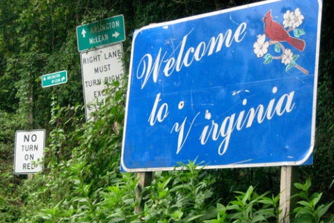 A road sign that says "Welcome to Virginia." We also see signs reading "No Turn on Red" and "Right Lane Must Turn Right."