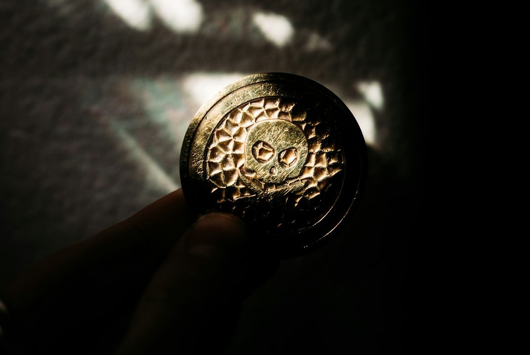 person holding silver round coin