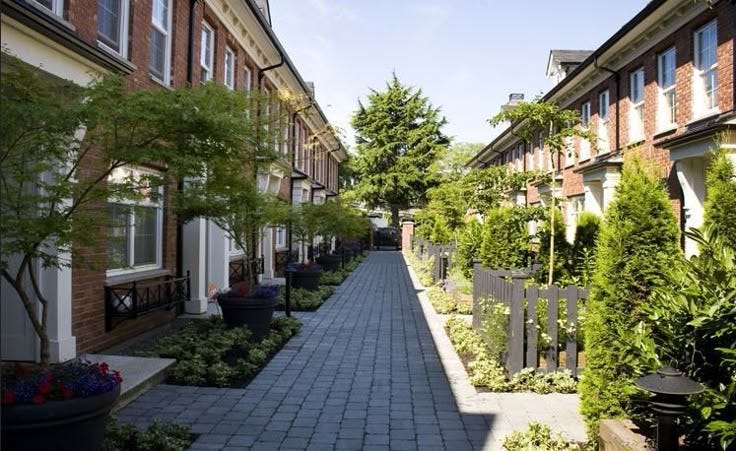 This may contain: a brick walkway between two row houses